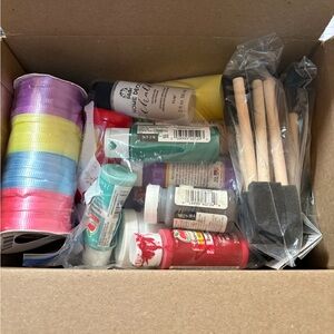 Assorted paints, curling ribbon, paint sponges and sandpaper for crafts.